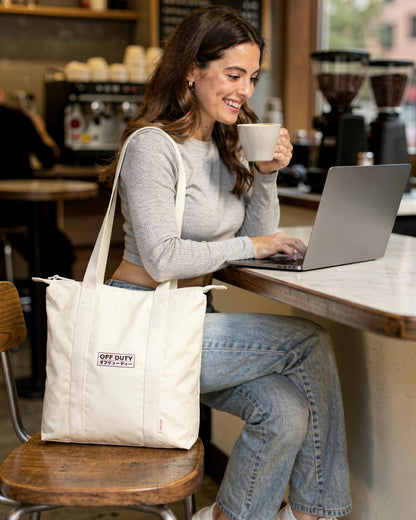 Off Duty Day Trip Tote in Ivory, working in a coffee shop — od-color:ivory