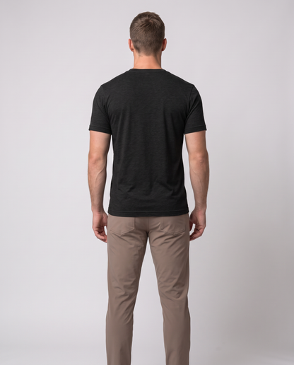 Off Duty Men's Triblend Tee in Black on a studio model, back-facing view