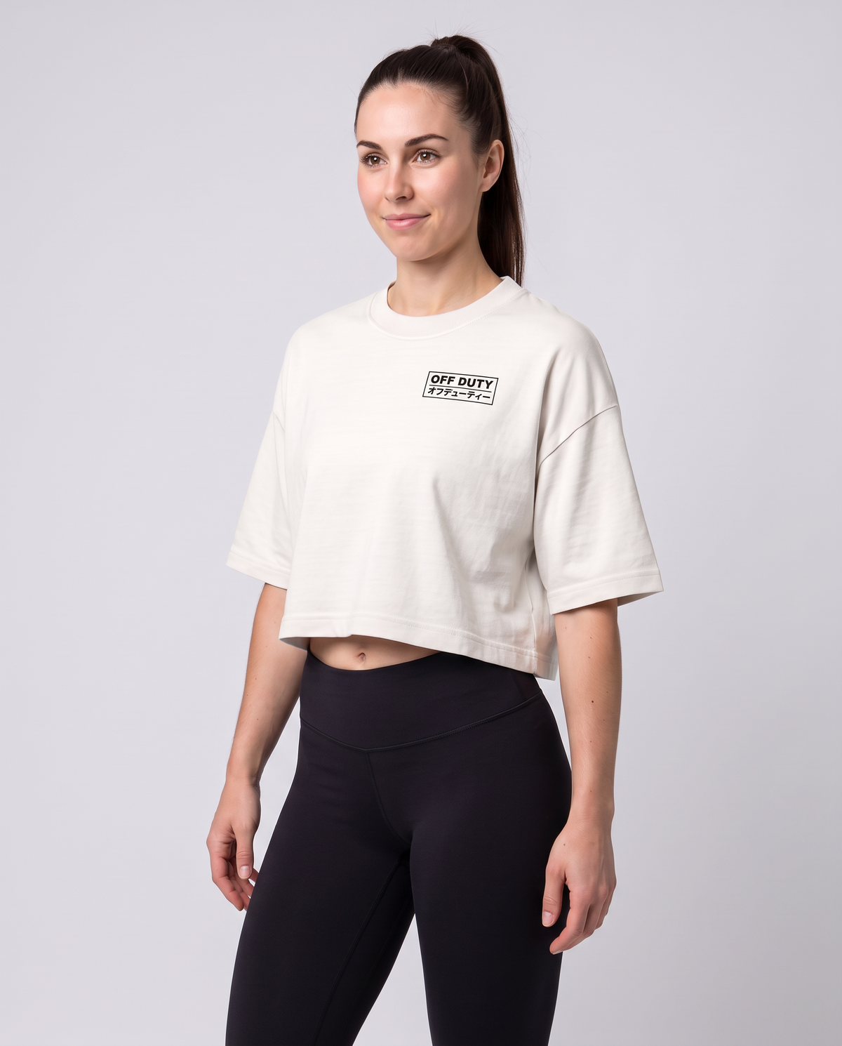 Off Duty The Weekend Cropped Tee in Vintage White on model, scene 5 — od-color:vintage-white